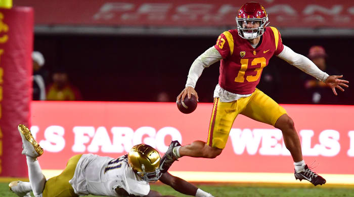 USC QB Caleb Williams runs the ball past a fallen Notre Dame defender